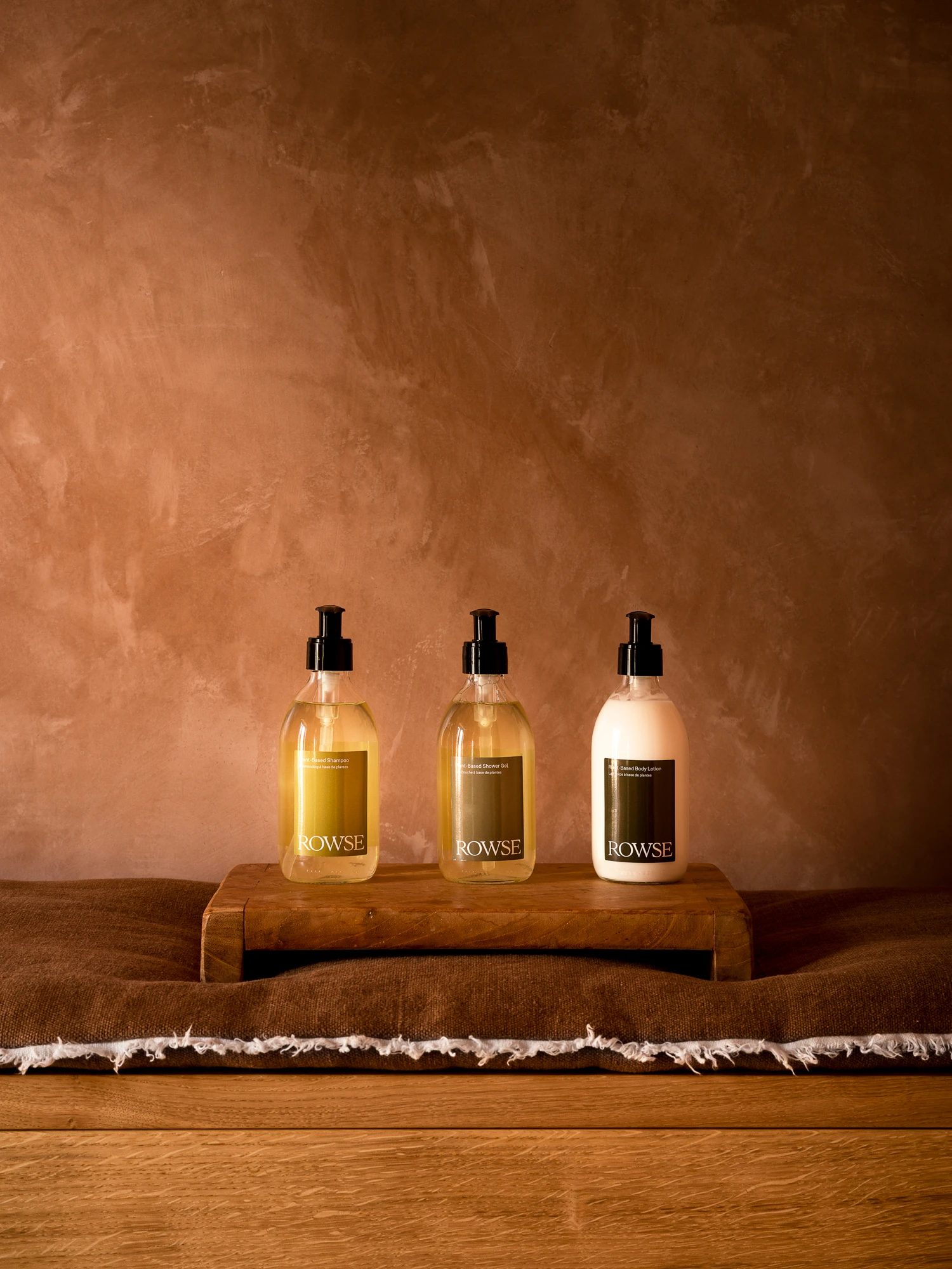 Rowse wellness bottles arranged on a wooden tray over a linen cloth.