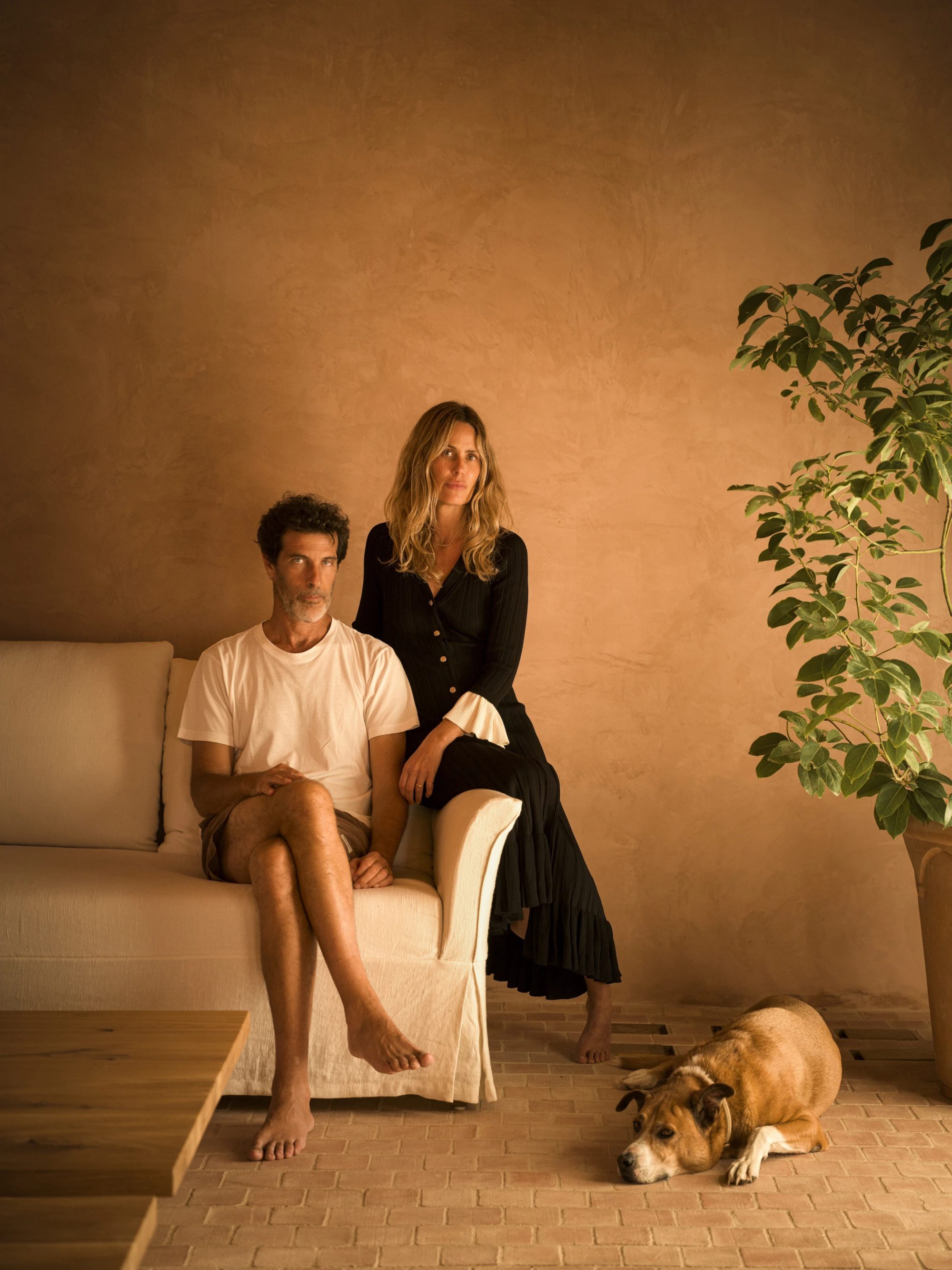 RockRose founders Marta Alvim and Vasco Maya, seated in the house with their dog.